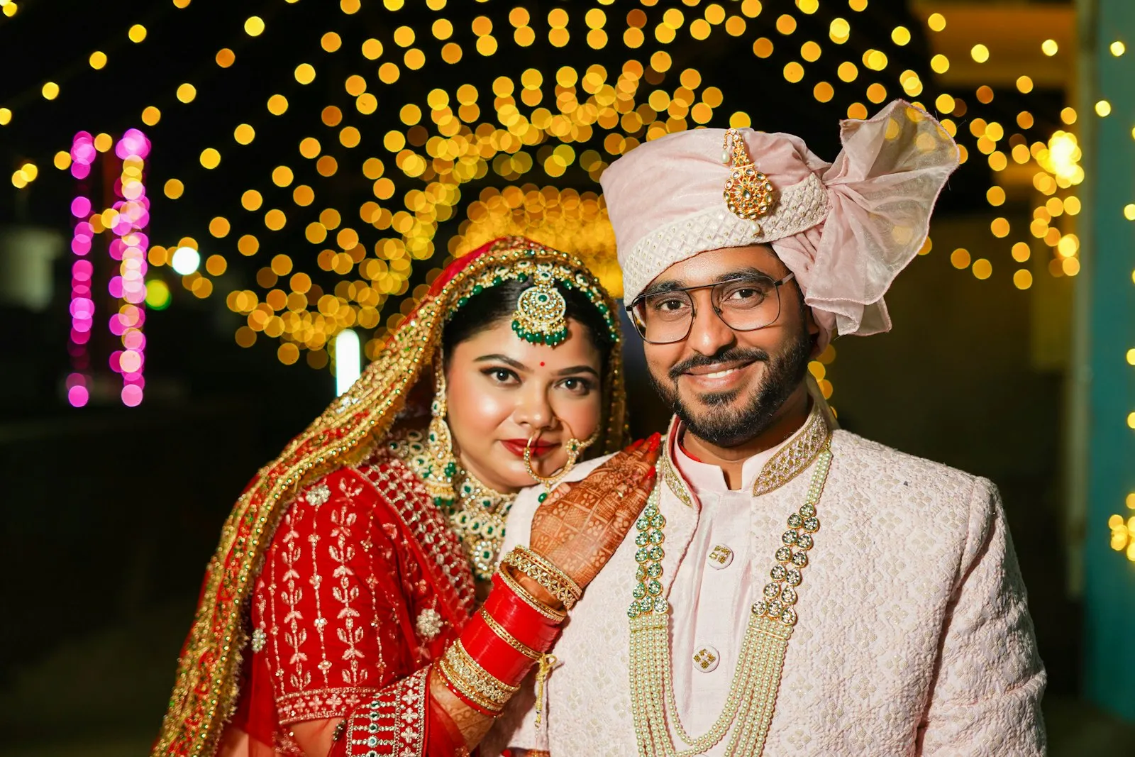 Bride and groom close together under warm lights